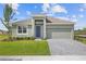 Charming single-story home featuring a manicured lawn, brick paver driveway, and a two-car garage at 1580 Gardiner St, Haines City, FL 33844
