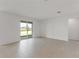 Bright living area with sliding glass doors providing access to the outdoors and natural light at 1580 Gardiner St, Haines City, FL 33844