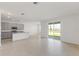 Open floor plan with tile flooring connecting the kitchen to a spacious living area at 1580 Gardiner St, Haines City, FL 33844