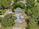 Aerial view of the neighborhood highlights mature trees, carport, and inground pool nearby at 1607 Lindale Ave, Eustis, FL 32726