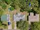 Aerial view of the neighborhood shows the house and backyard, a shed, a carport, and mature landscaping at 1607 Lindale Ave, Eustis, FL 32726