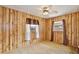 Bedroom featuring wood paneling, a ceiling fan, and natural lighting at 1607 Lindale Ave, Eustis, FL 32726