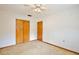 Bright bedroom featuring neutral walls, ceiling fan, and closet space at 1607 Lindale Ave, Eustis, FL 32726