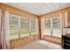 Light-filled bonus room with wood paneling and large windows, creating a cozy atmosphere at 1607 Lindale Ave, Eustis, FL 32726