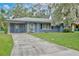 Charming single-story home with a well-maintained lawn and a long driveway at 1607 Lindale Ave, Eustis, FL 32726