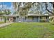 Charming single-story home with a well-maintained lawn and mature trees at 1607 Lindale Ave, Eustis, FL 32726