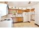 Functional kitchen featuring vintage appliances, wood cabinets, and ample counter space at 1607 Lindale Ave, Eustis, FL 32726