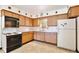 Cozy kitchen with wood cabinets, tile flooring, and essential appliances at 1607 Lindale Ave, Eustis, FL 32726
