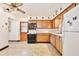 Kitchen featuring appliances, wood cabinets, and tile flooring, ready for Gathering meals at 1607 Lindale Ave, Eustis, FL 32726