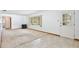 Bright living room featuring a mix of carpet and tile flooring and a large window at 1607 Lindale Ave, Eustis, FL 32726