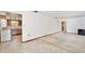 Open living area with tile flooring transitioning to carpet, next to the kitchen at 1607 Lindale Ave, Eustis, FL 32726