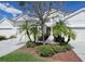 Inviting two-story townhome with well-maintained lawn, decorative trees, and mulch beds at 1730 Spicebush Ct, Orlando, FL 32828