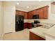 Kitchen with stainless steel appliances, wood cabinets, and tile flooring at 1730 Spicebush Ct, Orlando, FL 32828