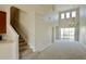Bright open-concept living room with high ceilings, carpeted floors, and staircase at 1730 Spicebush Ct, Orlando, FL 32828