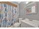 Clean bathroom with a modern sink and blue patterned shower curtain at 210 Magnolia Rd # 214, Maitland, FL 32751