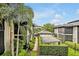 Beautifully landscaped community featuring lush greenery, palm trees, and well-maintained buildings under a bright sky at 210 Magnolia Rd # 214, Maitland, FL 32751