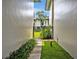 Charming green space nestled between buildings, featuring lush vegetation, a walkway, and a tranquil atmosphere at 210 Magnolia Rd # 214, Maitland, FL 32751