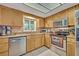 Well-lit kitchen with stainless steel appliances and granite countertops at 210 Magnolia Rd # 214, Maitland, FL 32751