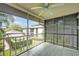 Relaxing screened patio with a ceiling fan and serene views of the surrounding lush greenery, perfect for enjoying outdoors at 210 Magnolia Rd # 214, Maitland, FL 32751