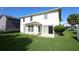 A backyard featuring manicured lawn, patio, and partial view of the home at 2205 Wyndam Way, Kissimmee, FL 34743