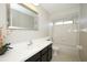 Well-lit bathroom featuring a white vanity, sink, large mirror, and tub/shower combo at 2205 Wyndam Way, Kissimmee, FL 34743