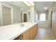 Bathroom with a long vanity with double sinks and an arched window above a soaking tub at 2205 Wyndam Way, Kissimmee, FL 34743