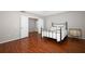 Bedroom features wood floors, an iron bed frame, and neutral colors at 2205 Wyndam Way, Kissimmee, FL 34743