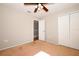 Bright bedroom with a ceiling fan, closet, and door to the hallway at 2205 Wyndam Way, Kissimmee, FL 34743