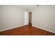 Neutral bedroom with wood floors and a white door at 2205 Wyndam Way, Kissimmee, FL 34743