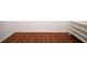 Walk-in closet featuring hardwood floors and built-in white shelving for organized storage at 2205 Wyndam Way, Kissimmee, FL 34743