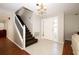Elegant foyer with staircase, chandelier, tile flooring, and a glass-paneled front door at 2205 Wyndam Way, Kissimmee, FL 34743