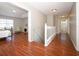 Hallway featuring gleaming wood floors that lead to a bedroom with a fireplace at 2205 Wyndam Way, Kissimmee, FL 34743