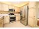 Spacious kitchen featuring stainless steel appliances and tiled flooring at 2205 Wyndam Way, Kissimmee, FL 34743