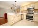 Modern kitchen with stainless steel appliances and ample countertop space at 2205 Wyndam Way, Kissimmee, FL 34743