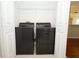 Laundry closet featuring a black washer and dryer at 2205 Wyndam Way, Kissimmee, FL 34743