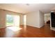 Open-concept living room with hardwood floors, sliding glass doors, and ample space at 2205 Wyndam Way, Kissimmee, FL 34743