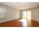 Bright living room featuring hardwood floors, sliding glass doors and ample natural light at 2205 Wyndam Way, Kissimmee, FL 34743