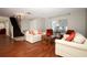 Cozy living room with hardwood floors, staircase, chandelier, and stylish furnishings at 2205 Wyndam Way, Kissimmee, FL 34743