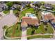 Aerial view of single Gathering home with a private backyard pool and mature landscaping at 2223 Fairmont Cir, Orlando, FL 32837