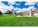 View of backyard featuring a sparkling pool, lush lawn, and white privacy fence at 2223 Fairmont Cir, Orlando, FL 32837