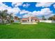 Expansive backyard featuring a sparkling pool, lush lawn, and white privacy fence at 2223 Fairmont Cir, Orlando, FL 32837