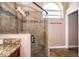 Bathroom boasting a tiled shower with a glass door and a granite vanity at 2223 Fairmont Cir, Orlando, FL 32837