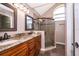 Elegant bathroom featuring granite countertops, vanity, and a tiled glass shower enclosure at 2223 Fairmont Cir, Orlando, FL 32837