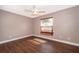 Cozy bedroom with a ceiling fan, wood laminate floors, and natural light at 2223 Fairmont Cir, Orlando, FL 32837