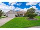 Charming single-story home featuring a well-maintained lawn and a two-car garage at 2223 Fairmont Cir, Orlando, FL 32837