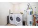 Functional laundry room including a washer, dryer, utility sink, and water heater at 2223 Fairmont Cir, Orlando, FL 32837