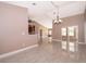 Open-concept living area featuring modern tile floors and a decorative chandelier at 2223 Fairmont Cir, Orlando, FL 32837