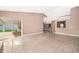 Open-concept living room boasts tile floors and natural light from sliding glass doors at 2223 Fairmont Cir, Orlando, FL 32837