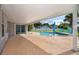 A covered patio overlooks the pool and lush backyard, great for entertaining at 2223 Fairmont Cir, Orlando, FL 32837