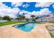Sparkling backyard pool with inviting patio seating, palm trees and privacy fence at 2223 Fairmont Cir, Orlando, FL 32837